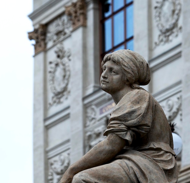 A statue of a woman sits in front of a building that says'i love spain '