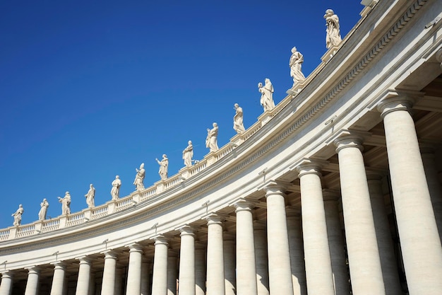 Statues in St Peter Square Rome Italy with blue sky background