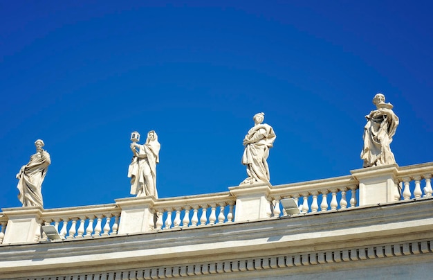 Statues in St Peter Square Rome Italy with blue sky background