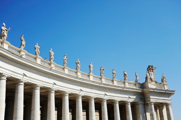 Statues in St Peter Square Rome Italy with blue sky background