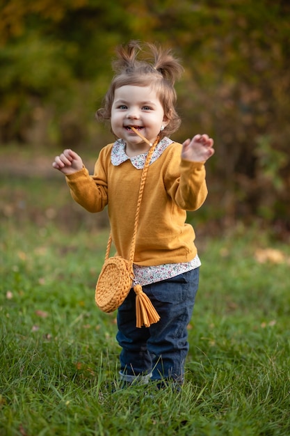 STAVROPOL, RUSSIA, 5 OCTOBER 2019; A little girl with a knitted handbag walks in the Park