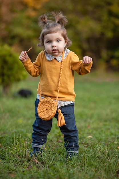 STAVROPOL, RUSSIA, 5 OCTOBER 2019; A little girl with a knitted handbag walks in the Park