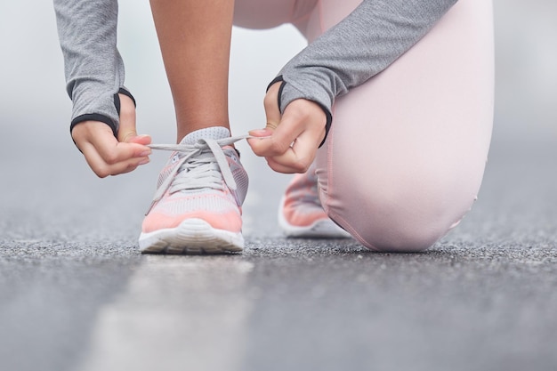 Stay focused on your end goal Closeup shot of an unrecognizable persn tying their shoelaces while exercising