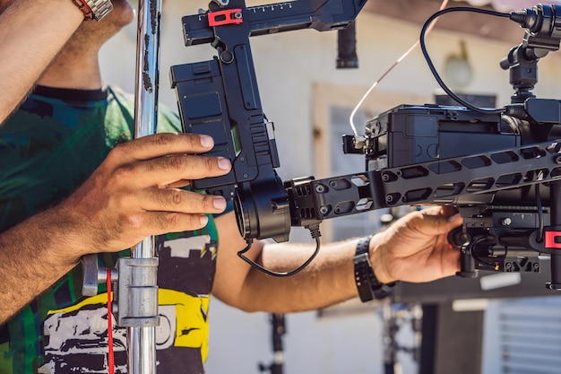 Steadicam operator prepare camera and 3axis stabilizergimbal for a commercial shoot