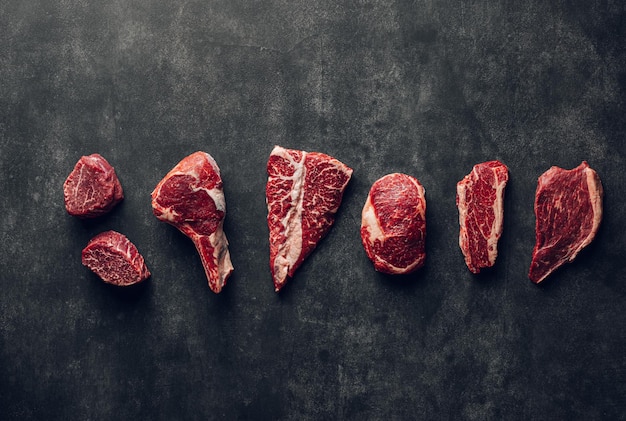 Steak collection on dark stone background