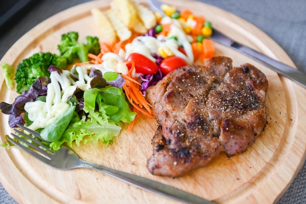 Steak homemade with french fries and fresh vegetable salad on wooden tray healthy steak menu Steak pork