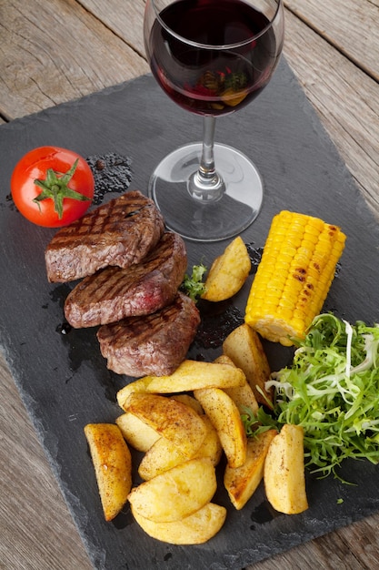 Steak with grilled potato corn salad and red wine