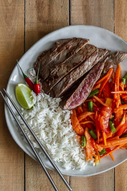 Steak with salad and rice. Food and drinks, top view