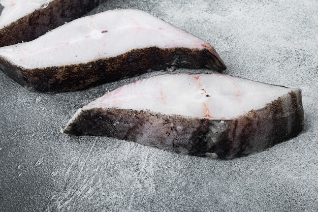 Steaks of fish and fillet of sea fish frozen set, on gray stone table background