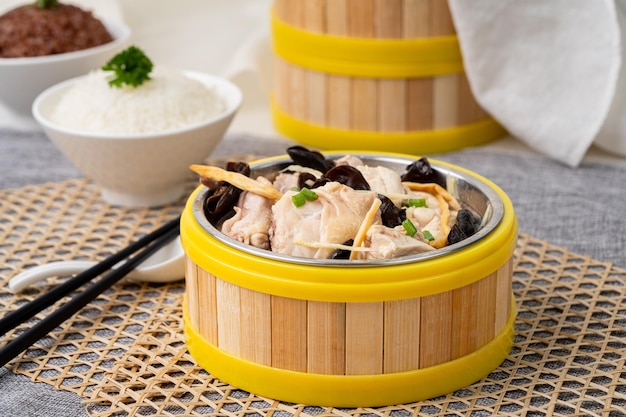 STEAM CHICKEN With FUNGUS and DRIED LILY FLOWER with chopsticks served in dish isolated on table top view of singapore food