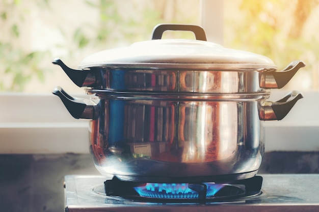 Steam over cooking pot in kitchen