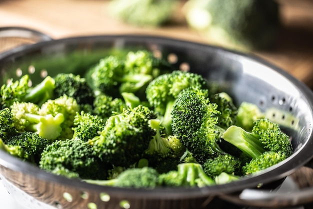 Steamed broccoli in a stainless steel steamer Close up Healthy vegetable concept