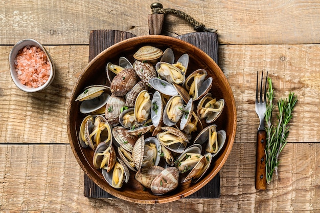 Steamed cooked shells Clams vongole in a wooden plate