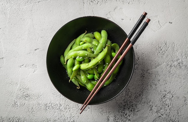 Steamed edamame soybeans on a gray concrete background view from above