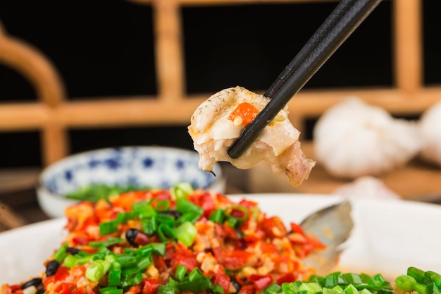 Steamed fish head with diced hot red peppers