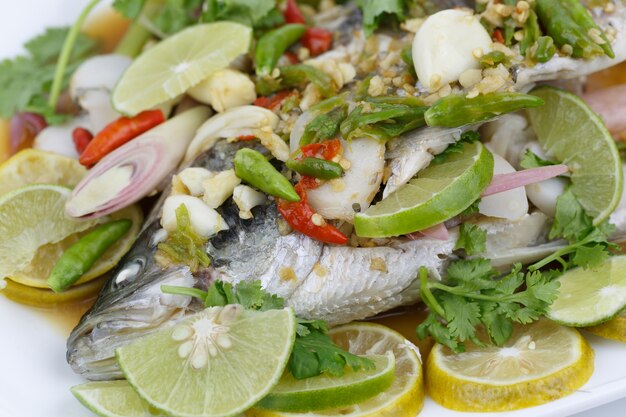 Steamed Fish in Lemon Sauce on White Plate