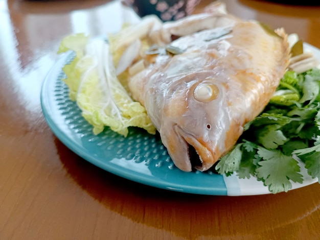 Steamed Fish with Chili Lime Saucethai Traditional Thai food thai style steamed fish on table cl