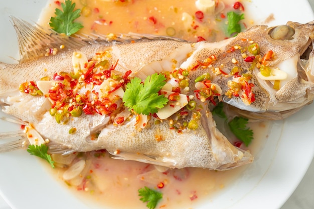 Steamed grouper fish with lime and chillies - Asian food style