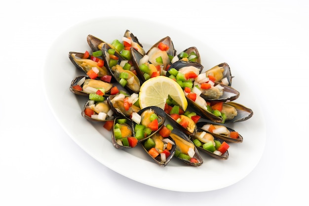 Steamed mussels with peppers and onion isolated on white background