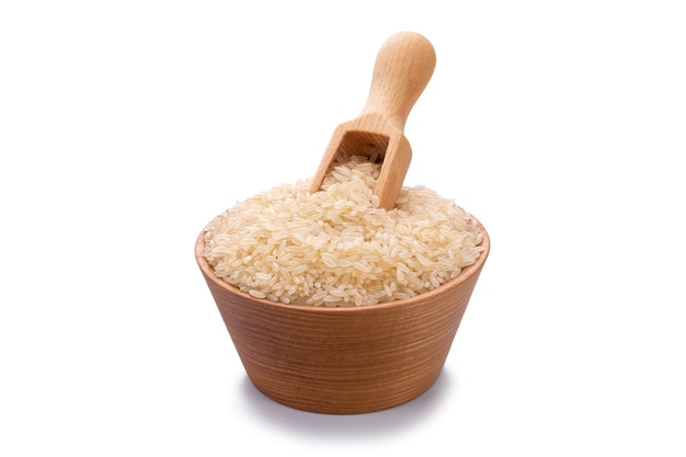 Steamed rice in a wooden scoop and in a bowl isolated on white background