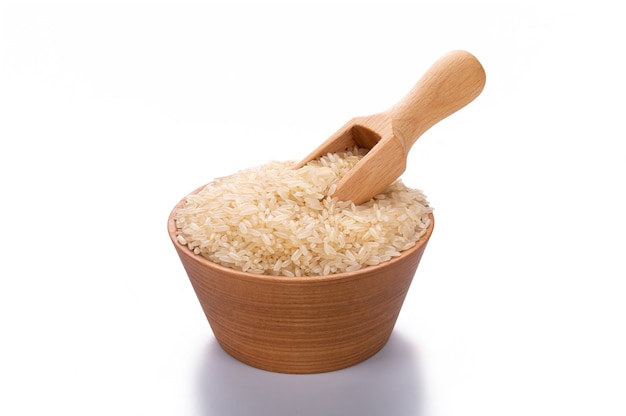 Steamed rice in a wooden scoop and in a bowl isolated on white background