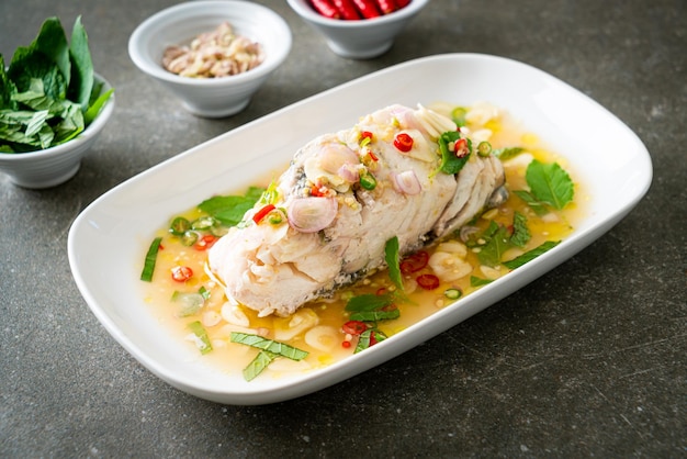 Steamed sea bass fish with herbs