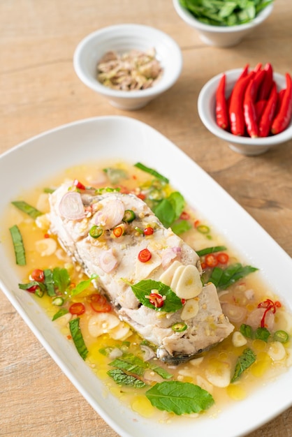 Steamed sea bass fish with herbs