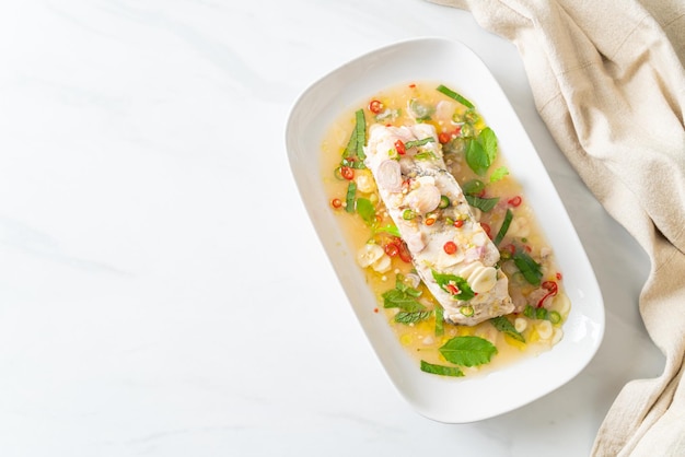 Steamed sea bass fish with herbs