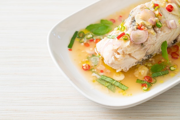 Steamed sea bass fish with herbs