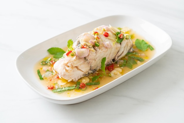 Steamed sea bass fish with herbs