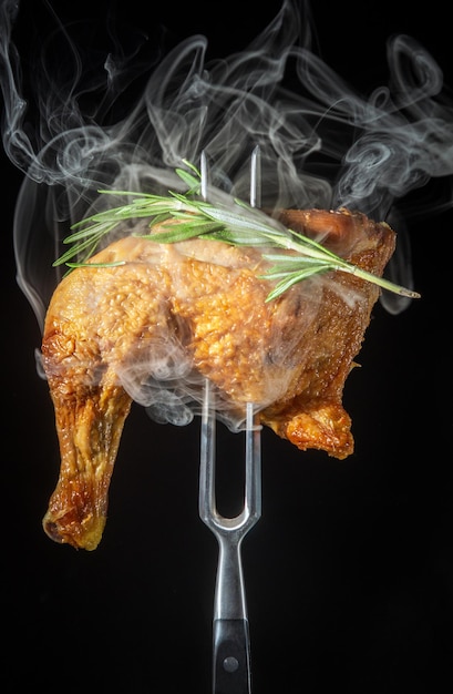 Steamed smoked chicken thigh with rosemary on a fork Menu for restaurant or hotel