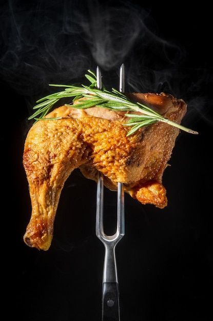 Steamed smoked chicken thigh with rosemary on a fork Menu for restaurant or hotel