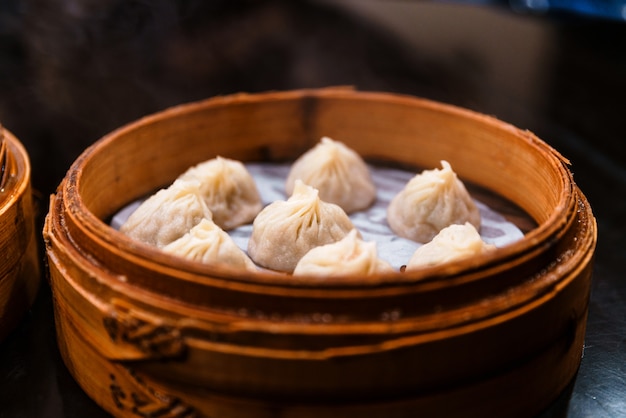 Steamed Xiao Long Bao (Soup Dumplings) in The Bamboo Basket. Served in Restaurant in Taipei, Taiwan.