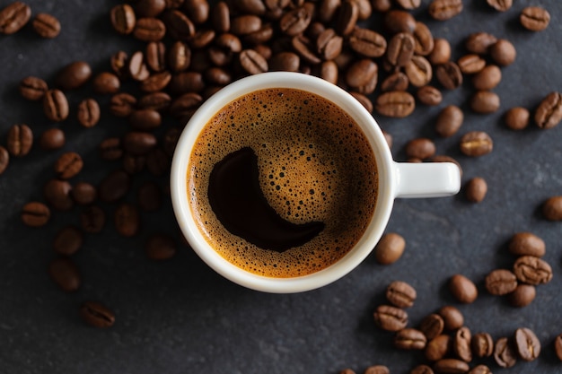 Steaming espresso cup on grey background. Closeup