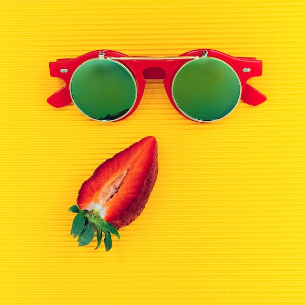 Photo steampunk sunglasses and strawberries. fashion minimalism mix