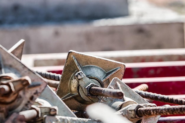 Steel clamps or waler brackets holding forms or forming panels during formwork on construction building site Concrete cement wall pouring Rough texture surface