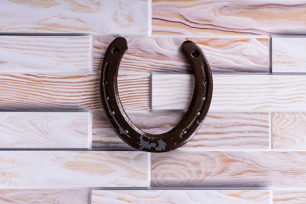 Photo steel horseshoe on a wooden , brings luck, symbol