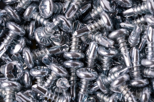 Steel selftapping screws metal screw iron screw chromeplated selftapping screw scattered screws as a background