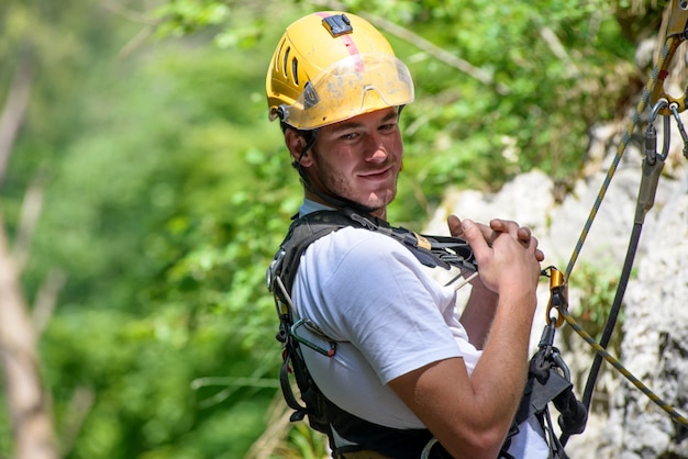 Steeplejack climbing a rock wall 