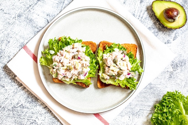 Step 11 Stepbystep preparation of a sandwich with tuna avocado cucumber and onion