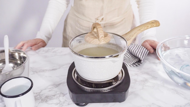 Step by step. Caramelizing sugar in a small cooking pot over the small electric stove.