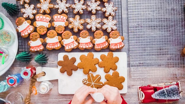 Step by step. Flat lay. Decorating gingerbread cookies with royal icing.