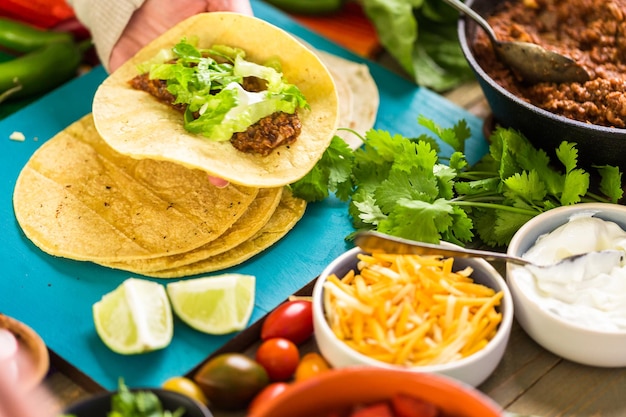 Step by step. Ground beef tacos with romaine lettuce, diced tomatoes, radished, and shredded cheddar cheese.