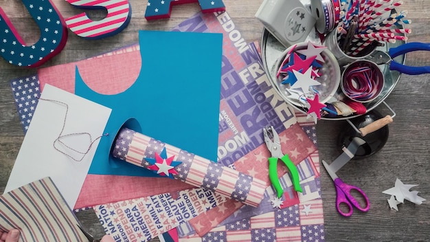 Step by step. Mother and daughter making paper firecrackers for July 4th celebration.