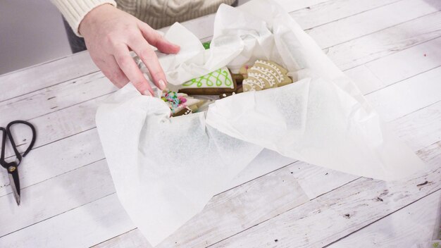 Photo step by step. packaging homemade fudge and cookies into a christmas gift box.