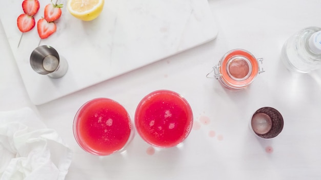 Step by step. Preparing Kentucky kiss bourbon cocktail with fresh organic strawberries.