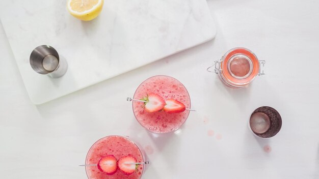 Step by step. Preparing Kentucky kiss bourbon cocktail with fresh organic strawberries.