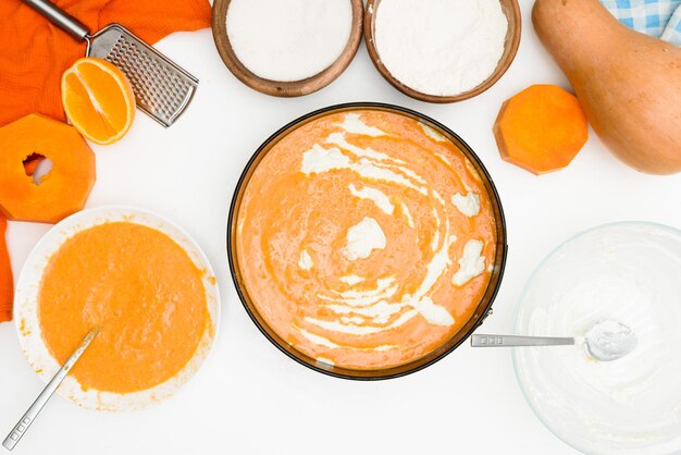 Step-by-step recipe for pumpkin curd casserole in the shape of a zebra, orange autumn pie with orange. ingredients for pumpkin pie are visible from the top