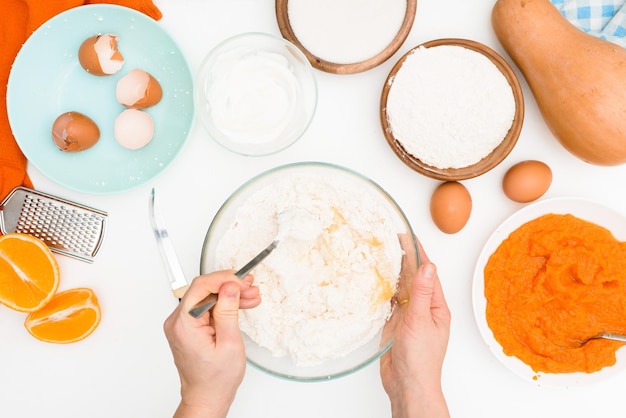 Step-by-step recipe for pumpkin curd casserole in the shape of a zebra, orange autumn pie with orange. mixing ingredients for pumpkin pie top view