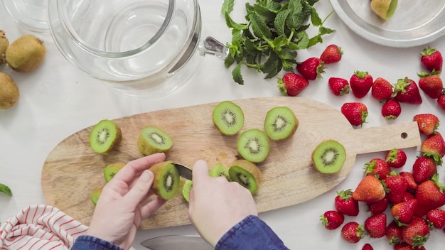 Step by step. Slicing fressh organic fruits for infused water.